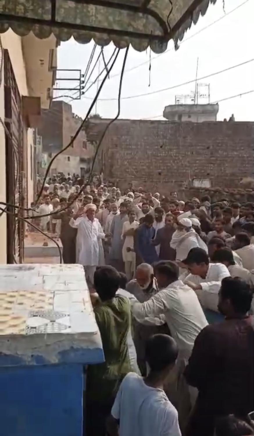 The crowd gathered outside the clinic in Gharial Kalan on 9 October 2026