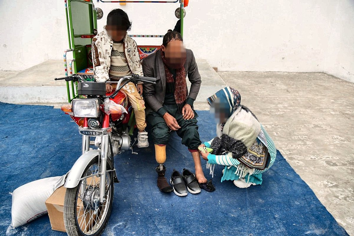 A family freed from brick kiln debt bondage with their new motorcycle rickshaw