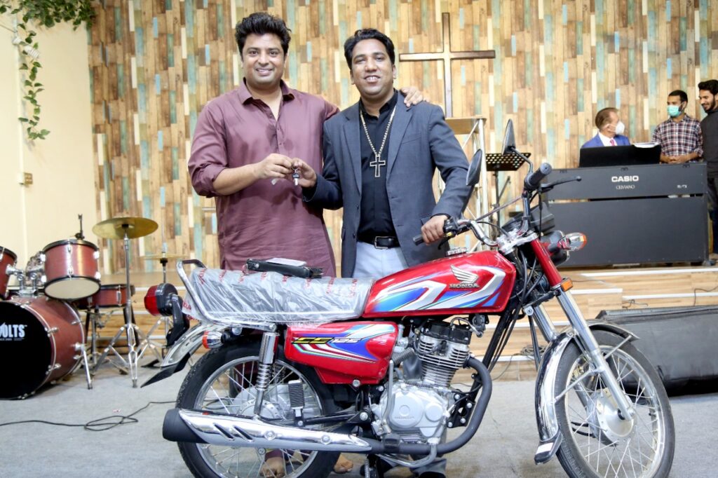 A pastor receives a motorbike in Pakistan